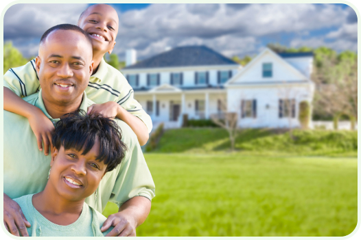 Two parents and their young son standing in the front yard of their home.