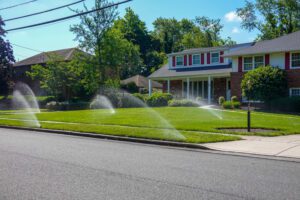 irrigation sprinklers watering lawn in front of house 1